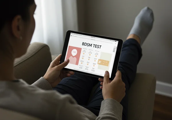 Person thoughtfully engaging with a BDSM test interface.
