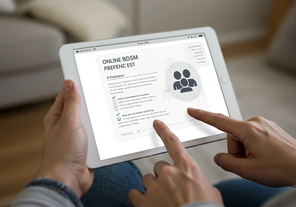 Person engaging with a BDSM preference test on a tablet.